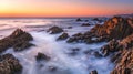 Tranquil rocky shore at dusk with dramatic sunset sky and illuminated horizon Royalty Free Stock Photo