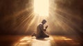 Christian man praying on floor by window with rays of golden light streaming through