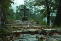 Serene cemetery pathway with cross tombstone