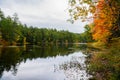 Tranquil scene with a mountain lake surrounded by woodlands on a cloudy autumn day Royalty Free Stock Photo