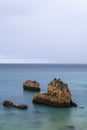 Tranquil scene of the rocks in the acean at the beautiful Ponta Joao de Arens in Portimao, Algarve