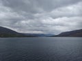 Tranquil Scene: Serene Landscape with Mountain, Lake, and Overcast Sky a view from uk Royalty Free Stock Photo