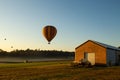 Tranquil scenery of air balloons reaching the sky from the countryside