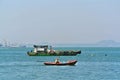 Scenery of Small Colorful Boat In Front of Green Fisherman Boat in the Sea