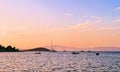 Tranquil seascape and coastal nature concept. Sea, boats, mountains and blue sky over horizon at sunrise