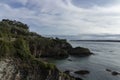 A Tranquil Seascape: Rocky Coastline Meets the Vast Blue Ocean