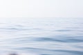 Tranquil and serene ocean surface. Calm and relaxed mirror-like blue sea background. Royalty Free Stock Photo