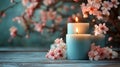 Tranquil setting with blooming cherry blossoms and lit candles on a rustic wooden surface Royalty Free Stock Photo