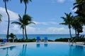 Caribbean Blue Pool and Chairs With View of Caribbean Sea