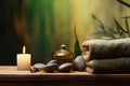 Tranquil spa concept sea stones balance on wooden table with candle, towel, and space for text