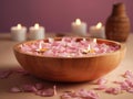 Tranquil spa setting with a wooden bowl of water and floating candles Royalty Free Stock Photo