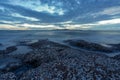 Tranquil stony bay after sunset. Slow shutter speed for smooth water level and dreamy effect. Royalty Free Stock Photo