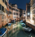 Tranquil canal with colorful buildings and boats at night, Venice, Italy Royalty Free Stock Photo