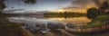 Tranquil sunrise over a lake and moored boats