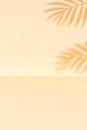 Tranquil tropical background with palm leaves casting shadows on a neutral tan colored two-tone surface creating a calm and Royalty Free Stock Photo