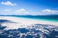 A tranquil tropical seascape on summer sunny, fantastic shadow of trees on pure sand beach