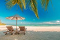 Beautiful beach. Chairs under palm trees sandy beach sea. Summer holiday and vacation concept for tourism. Inspirational beach Royalty Free Stock Photo