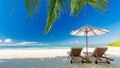 Beautiful beach. Chairs under palm trees sandy beach sea. Summer holiday and vacation concept for tourism. Inspirational beach Royalty Free Stock Photo