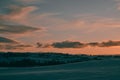 Tranquil winter scene featuring a purple sunset over the field Royalty Free Stock Photo