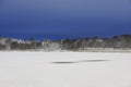 a tranquil winter scene with a frozen snow-covered lake