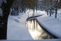 Winter scene with calm creek and frost-laden banks Royalty Free Stock Photo