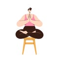 Tranquil woman on stool meditating sitting with crossed legs and folded hands in Namaste position