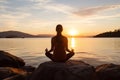 Tranquil woman practicing yoga at the beautiful seashore, captured from a captivating back view