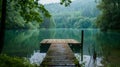 Serene lake view with wooden pier, surrounded by forest trees. calm water reflection, peaceful nature scene ideal for Royalty Free Stock Photo