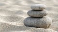 Three stacked stones in a minimalist zen garden with calm sand and gentle natural light Royalty Free Stock Photo