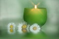 glowing candle with daisies