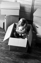 Tranquility Inside. happy little girl with toy. Cardboard boxes - moving to new house. purchase of new habitation Royalty Free Stock Photo