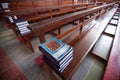 Tranquility place, Thai Catholic Prayer Book are on the rows of wooden church benches, soft beaming light shines in the church