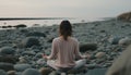 Tranquility at the seashore woman gracefully practicing yoga with a mesmerizing view of the ocean Royalty Free Stock Photo