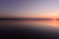 Tranquility sunset on the lake under the cloudless sky Royalty Free Stock Photo
