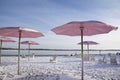 Tranquillity scene of beach chairs with umbrellas in winter