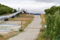 Close up view of the Trans Alaskan Pipeline and a dirt road in Delta Junction Alaska