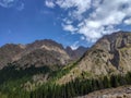 Trans-Ili Alatau mountain range of the Tien Shan system in Kazakhstan near the city of Almaty. Rocky peaks covered with snow and g Royalty Free Stock Photo