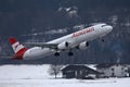 Austrian Airlines plane landing in Innsbruck Airport, INN, snow in winter Royalty Free Stock Photo