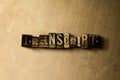 TRANSCRIPT - close-up of grungy vintage typeset word on metal backdrop