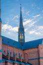 The transept tower of Uppsala cathedral an early summer morning. The lights not yet extinguished; a deep amber color is visible th