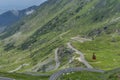 Transfagarasan - High altitude winding road in Carpathians mountains panorama with running cable car . Aerial view. Royalty Free Stock Photo