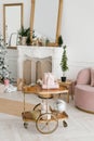 A transfer cart with Christmas decor and gifts in the interior of a classic living room