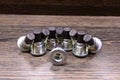 Transfer case drain plugs on wooden background