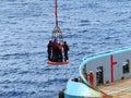 Transfer crews by personal basket from the platform to crews boat. Royalty Free Stock Photo