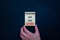 Transform fear into action symbol. Businessman holds wooden blocks with words `Transform fear into action`. Beautiful black