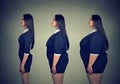 Transformation. Young fat woman becoming slim fit girl. Royalty Free Stock Photo