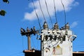 transformer and electric wooden pole against the blue sky.