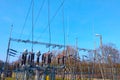 Transformer station close-up. Power lines against the blue sky. Royalty Free Stock Photo