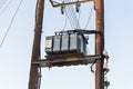 Transformers of an electrical post with powerlines against sky. Royalty Free Stock Photo