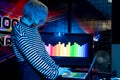 Transgender DJ tunes music track on laptop